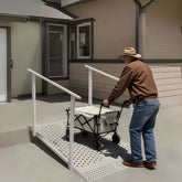 Person using a wheelchair ramp to enter a building