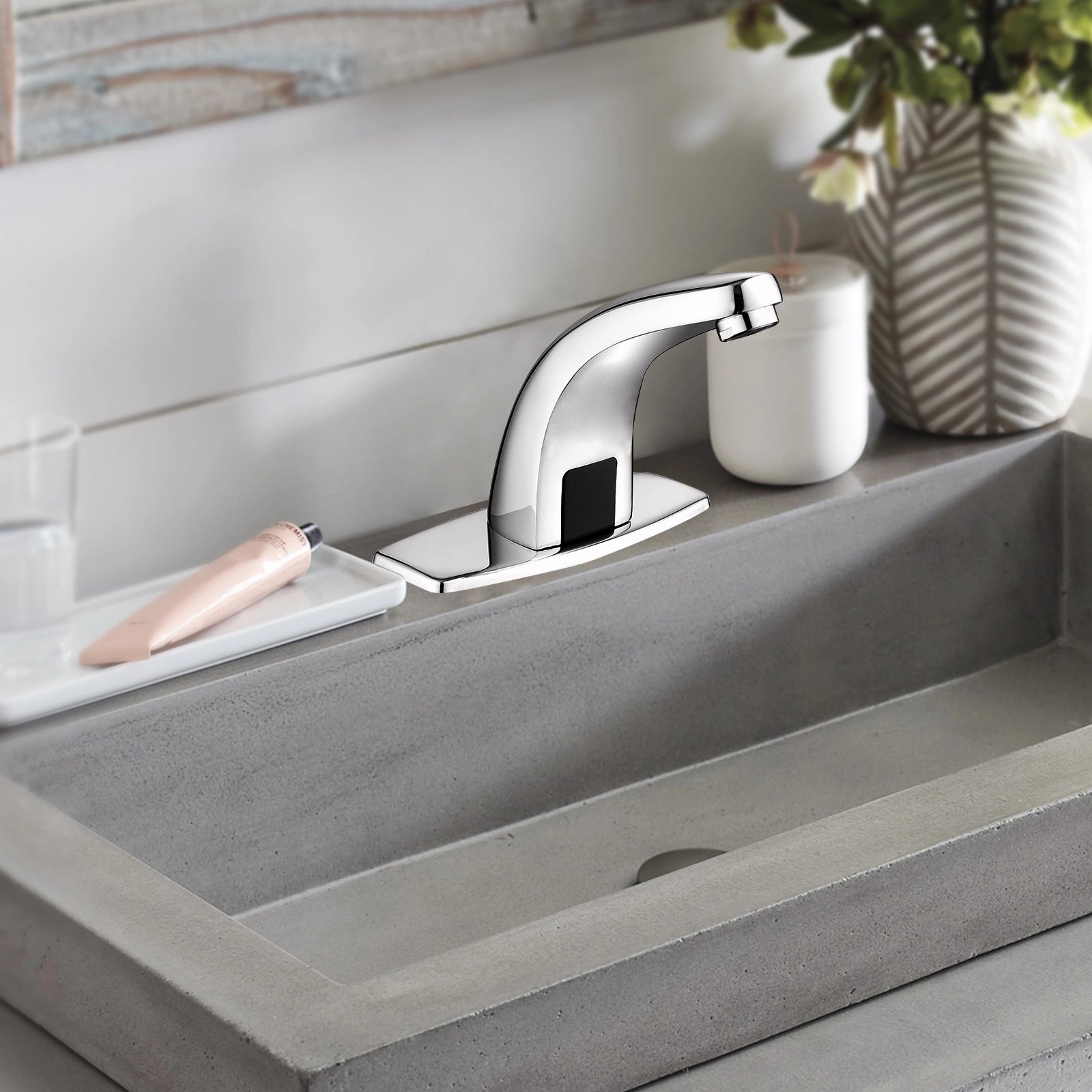 Touchless sink faucet with motion sensor installed on a modern bathroom sink in chrome finish