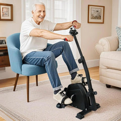 Man using a small exercise bike in a living room.