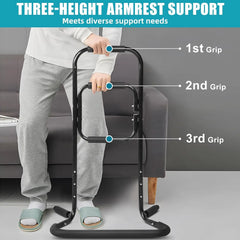Person using a three-height armrest support with labeled grips next to a sofa.