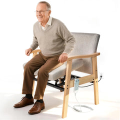 Man sitting on a modern chair with adjustable features on a white background